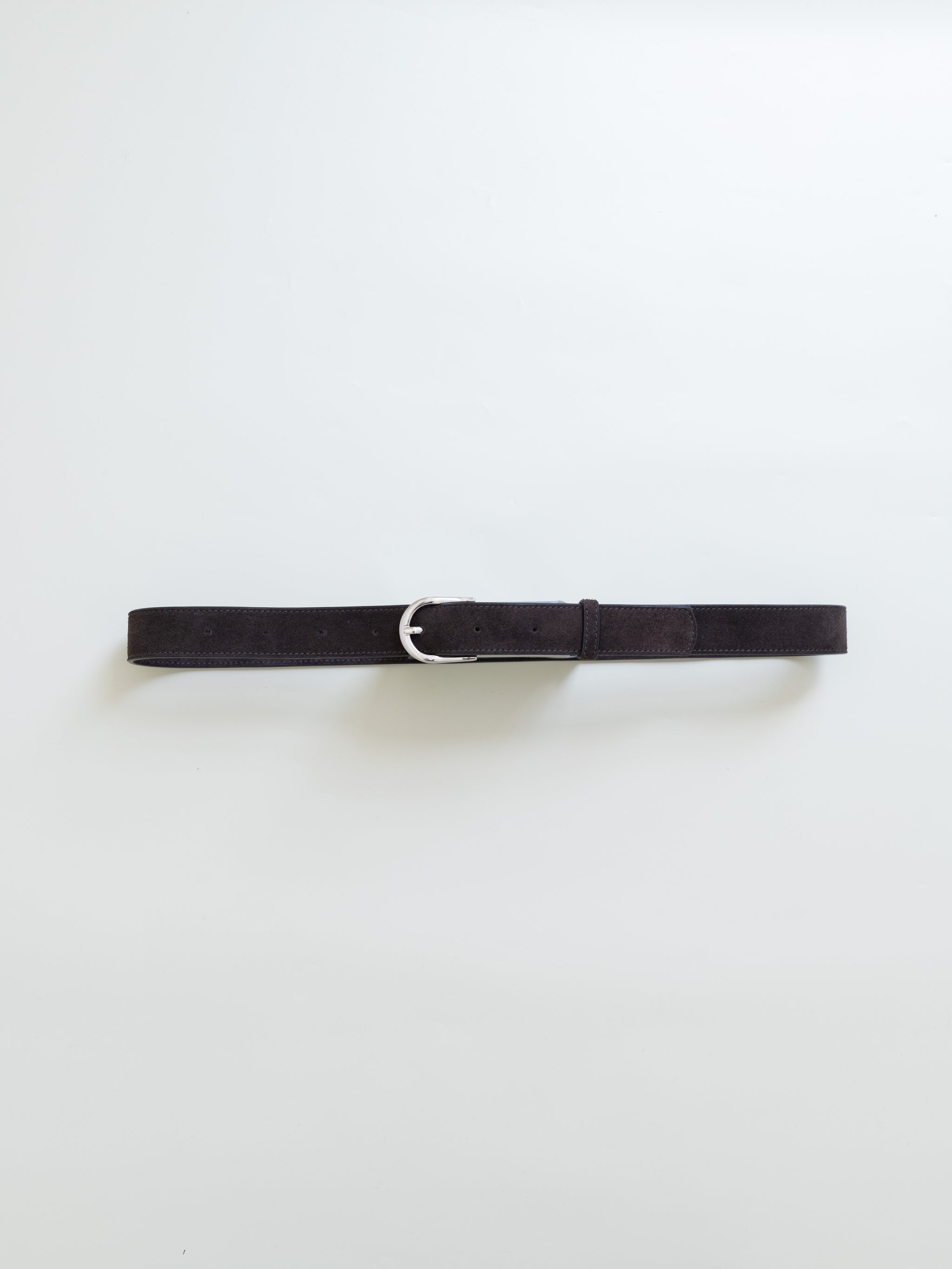 A brown leather belt with silver metal buckle on a white background. 