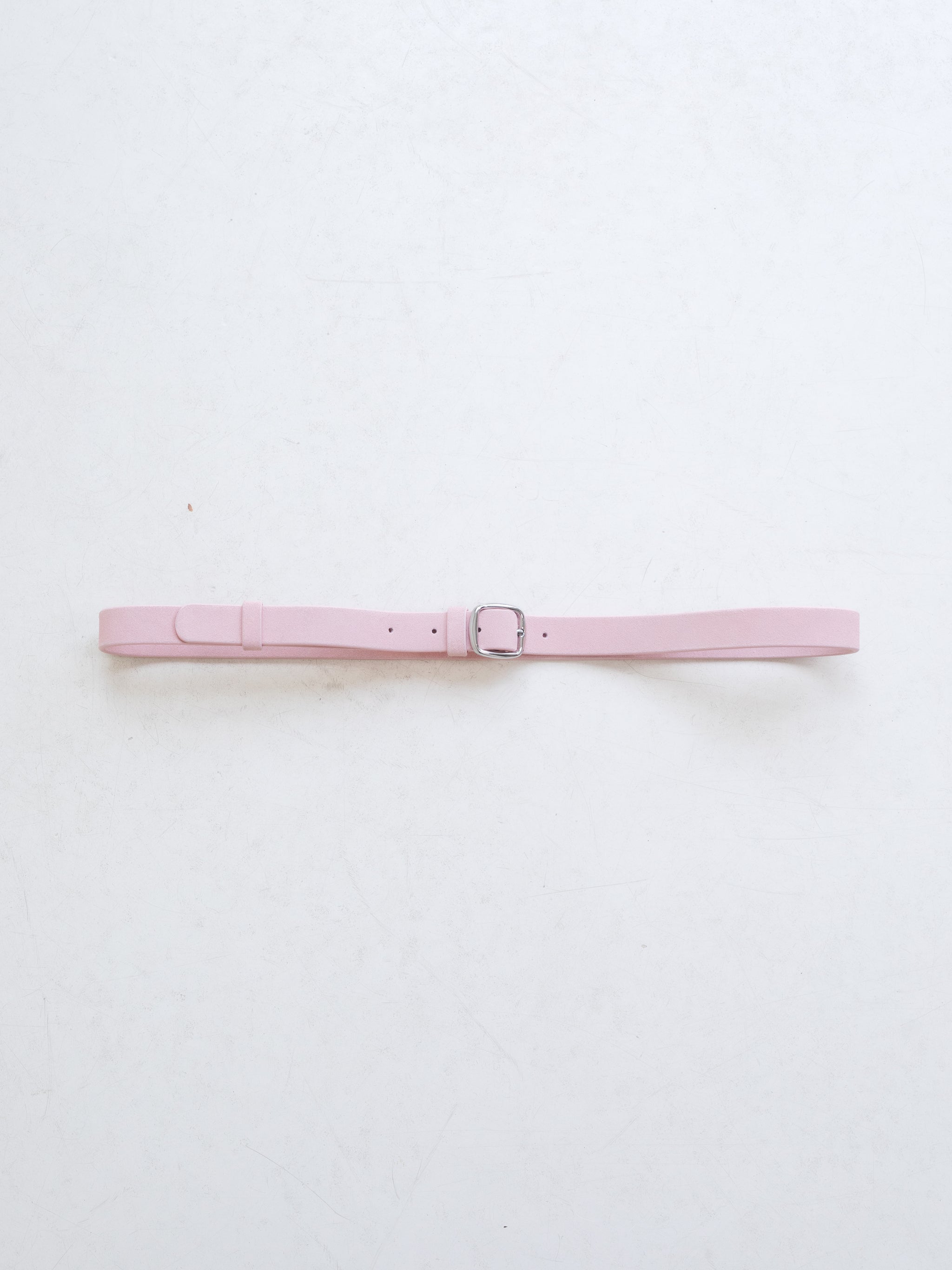 A bright pink leather belt with silver metal buckle on a white background. 