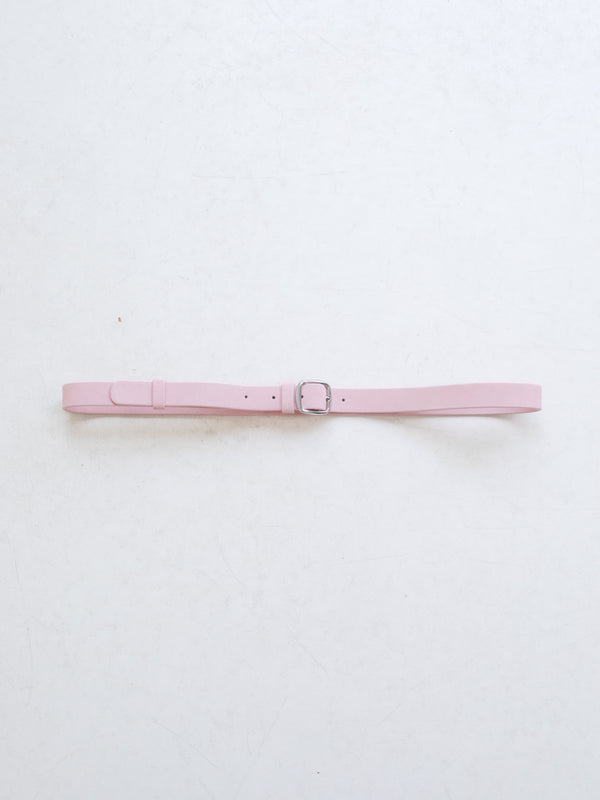A bright pink leather belt with silver metal buckle on a white background. 