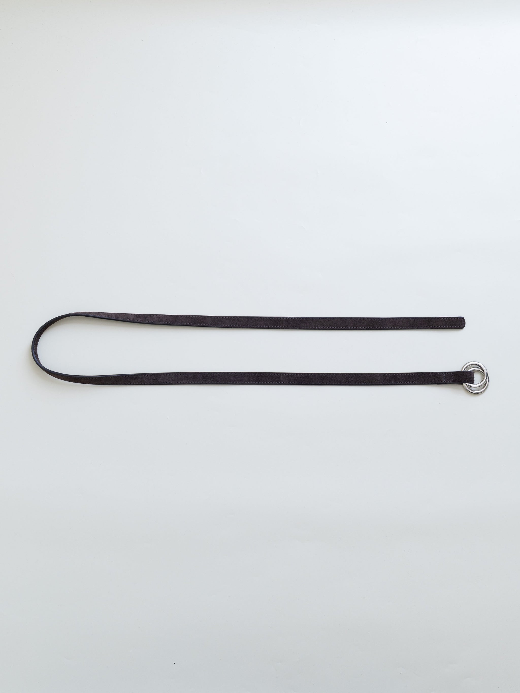 A brown leather belt with dual metal loops on a white background. 