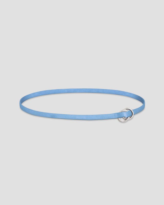 A light blue leather belt with dual metal loop closure on a white background. 